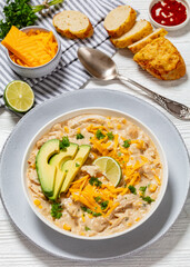 white chicken chili with cheese, avocado in bowl
