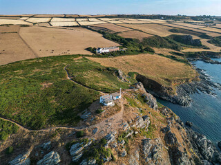 Fototapeta na wymiar Aerial view of Prawle Point, with Coast Guard station, and Coast Guard cottages behind