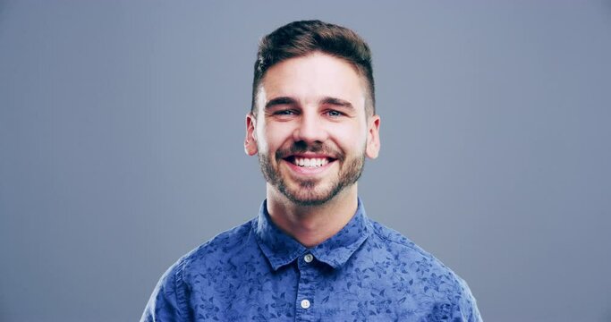 Man, thumbs up and happy for success, winning and thank you or support, like emoji and vote in studio. Face of excited person or winner for yes, ok and agreement hands or good news on gray background