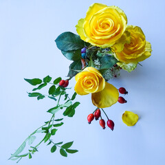 flower composition with yellow roses and dog rose - top view
