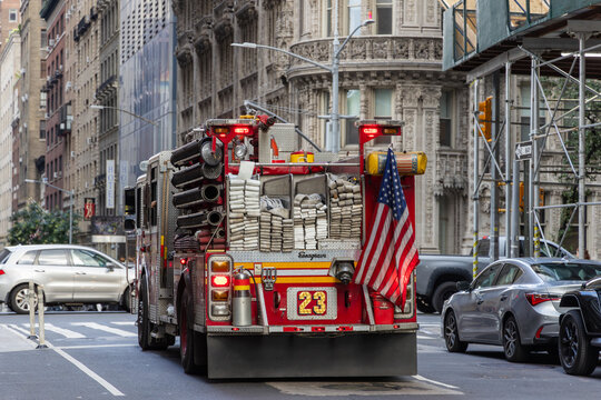 New York, NY, United States - July 23, 2023: Back view of a New York fire engine responding to an emergency call in Manhattan