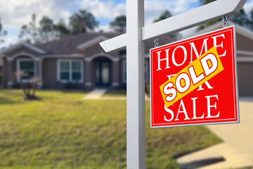 Sold Home For Sale Real Estate Sign in Front of Beautiful New House.