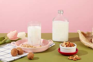 Concept of healthy life with nuts milk inside a cup and unlabeled bottle. Many nuts and beans are displayed. Nuts are a nutritionally rich food that good for health