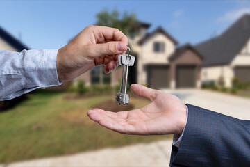 The real estate agent gives the keys to the meeting after the signing of the lease.