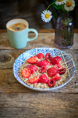 Oatmeal with cherries. wooden background, side view, healthy breakfast cereal.