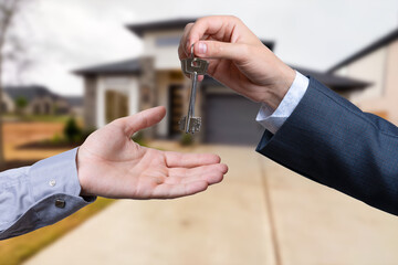 The real estate agent gives the keys to the meeting after the signing of the lease.