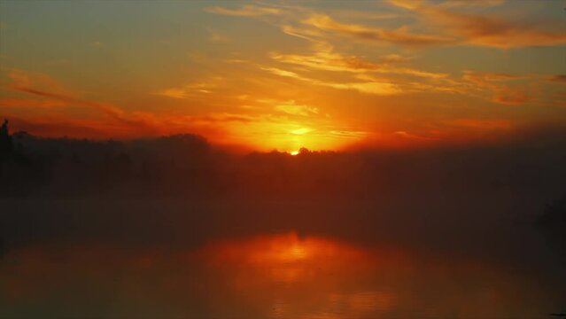 Landscape with sunrise cky over river at summer