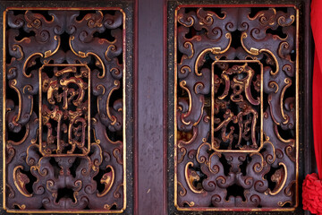 Antique Chinese calligraphy on top of the window of a century old Chinese Temple in the city of Melaka, Malaysia.