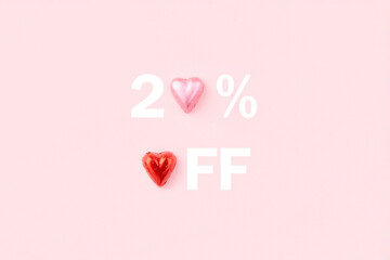 20 percent off sale banner. Heart shaped candies on pink background. 