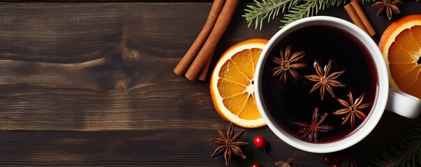 A glass of Christmas winter mulled red wine with spices cinnamon , orange, top view, flat lay, Autumn coffee composition. cup of tea or coffee, wide banner