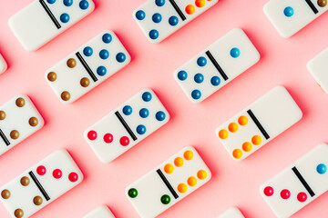 A pattern of domino pieces on pink background