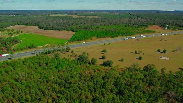 Semi trucks and trailers exiting truck stop from Jasper, Florida, USA. aerial view.
