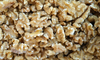 Many halves of fresh appetizing walnut closeup background. Healthy food concept