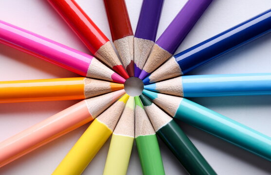 Multicolored pencils lying in shape of sun closeup. School of fine arts concept