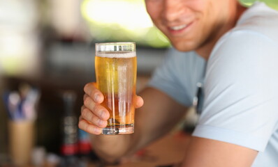 Young man drinking beer in bar closeup. Relaxation with alcohol concept