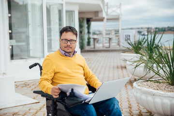 A person with a laptop outside a building on the street