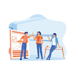 Naklejka premium Happy young businessman standing near whiteboard during a meeting in office. Give high fives to colleagues for work success achieved. Happy business people are celebrating success at the company 