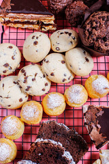 Table with various cookies, pound cake, cake slices, muffins and sweets.