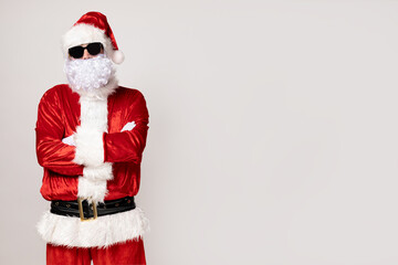 Cool Santa Claus in sunglasses on a light background.