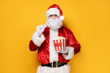 Fototapeta na wymiar Santa Claus, a cheerful Santa with popcorn in his hands.