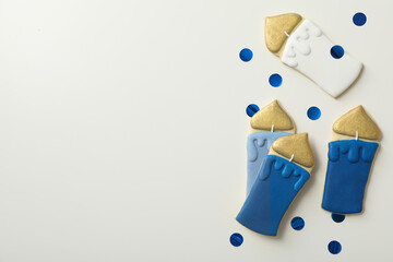 Gingerbread cookies and blue confetti on white background, space for text
