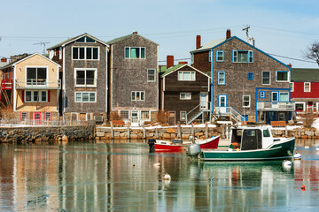 Lobster boats in the frozen inner harbor of Rockport at the tip of the Cape Ann peninsula on Atlantic coast of Massachusetts, USA
