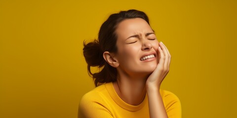 Fototapeta premium Portrait of an adult woman suffering from headache or toothache