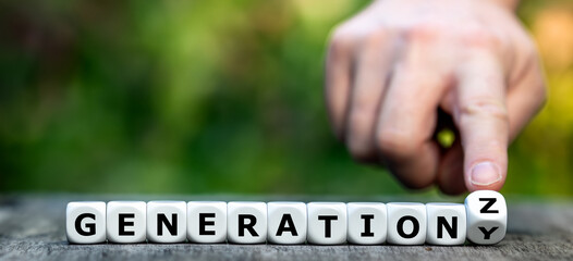 Hand turns dice and changes the expression 'Generation Y' to 'Generation Z'.