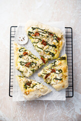 Homemade pizza with chicken and pesto sauce