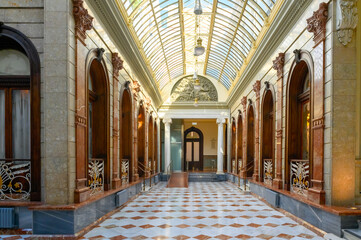 Fototapeta na wymiar Courtyard with glass ceiling. Architecture in Casino of Murcia (1853), Spain
