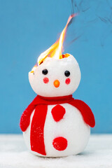 A toy snowman is on fire. Fire for the new year