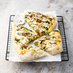 Homemade pizza with chicken and pesto sauce