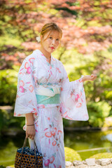 Portrait of a young woman wearing yukata summer kimono with soft blur background in a Japanese...