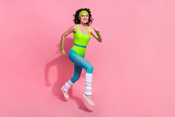 Photo of determined sporty lady trainer jump run fast sprint isolated on pastel color background