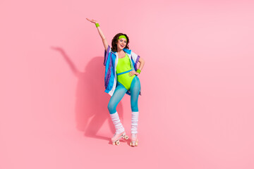 Photo of sporty lady coach doing street rink activity riding roller skates isolated on pastel color...
