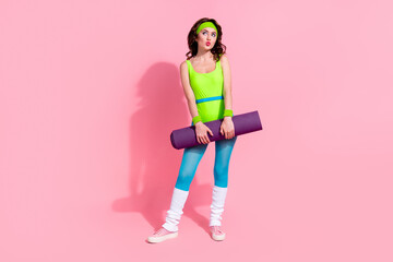 Photo of sporty lady trainer hold fitness mat look empty space on sport store sale discounts isolated pastel color background