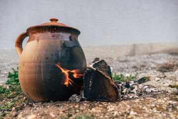 Traditional way of cooking in a clay pot by open fire