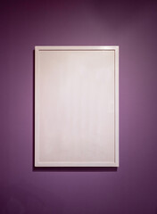 Blank white color picture frame template for place image inside on the violet wall