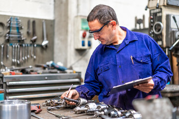 Factory worker operator of the numerical control sector measuring the drill bits, industrial factory