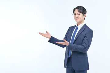 A young and handsome Asian man in a suit is wearing glasses and making various facial expressions and hand gestures.