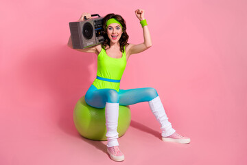 Photo of excited sporty lady trainer celebrate opening new sport club sit fitball with boom box...