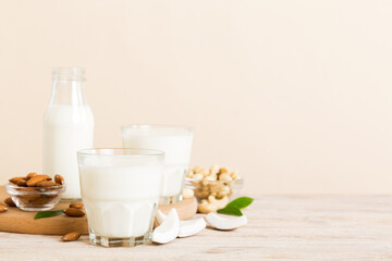 Obraz na płótnie Canvas Set or collection of various vegan milk almond, coconut, cashew, on table background. Vegan plant based milk and ingredients, top view
