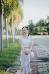 Portrait of a small, fit Asian woman exercising outside.
