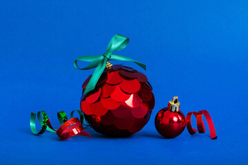 Christmas ball on colored background. decoration bauble with ribbon bow with copy space