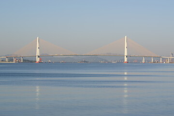 Fototapeta na wymiar Cross-sea bridge. Reflection.Morning