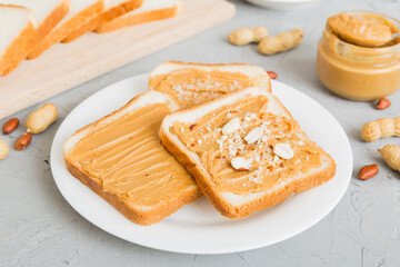 Peanut butter sandwiches or toasts on light table background.Breakfast. Vegetarian food. American cuisine top view vith copy space