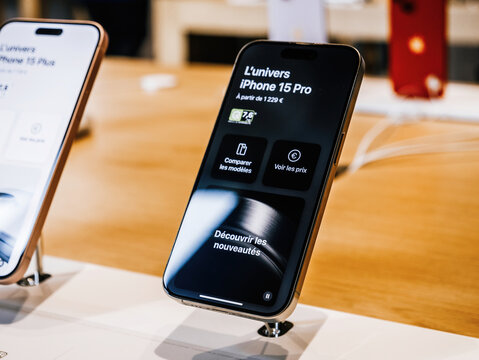 Paris, France - Sep 22, 2023: The universe of the new iPhone 15 Pro unfolds on a display at an Apple Store, captivating visitors during the highly anticipated product launch