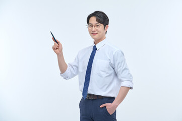 A young, handsome Asian man wearing glasses and a dress shirt and tie is holding a pen and...