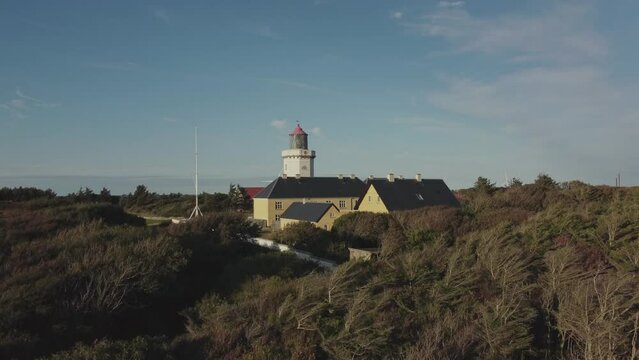 Hanstholm Fyr, Denmark - A Panoramic View of Lush Surroundings Encircling the Lighthouse - Aerial Pan Up