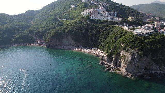 Aerial view of hidden sandy Mogren beach under the cliff in Budva, Montenegro